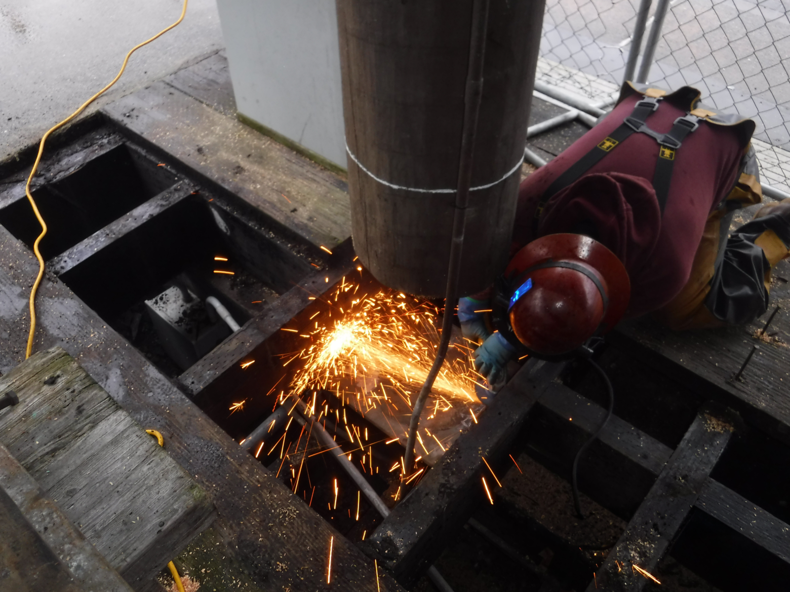 A contractor works on the dock piles at the Crescent Harbor High Load Dock.